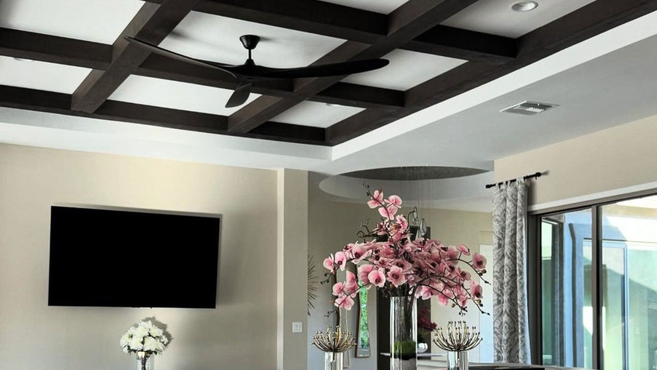A modern home with a coffered ceiling in a tray divit.