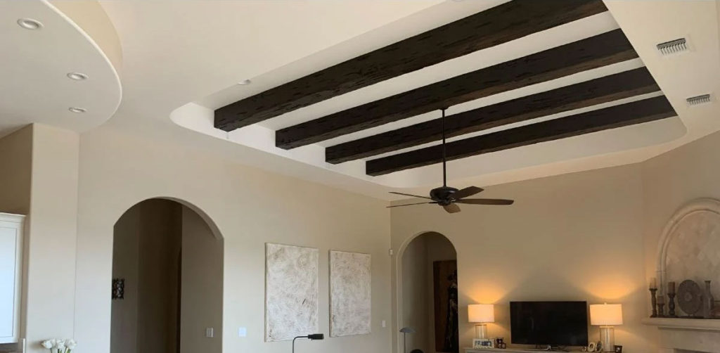 Tray ceiling with dark oak faux beams.