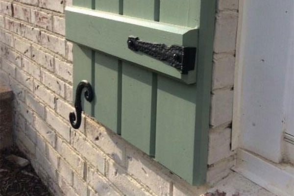 Decorative Shutter Hardware on a Green Shutter